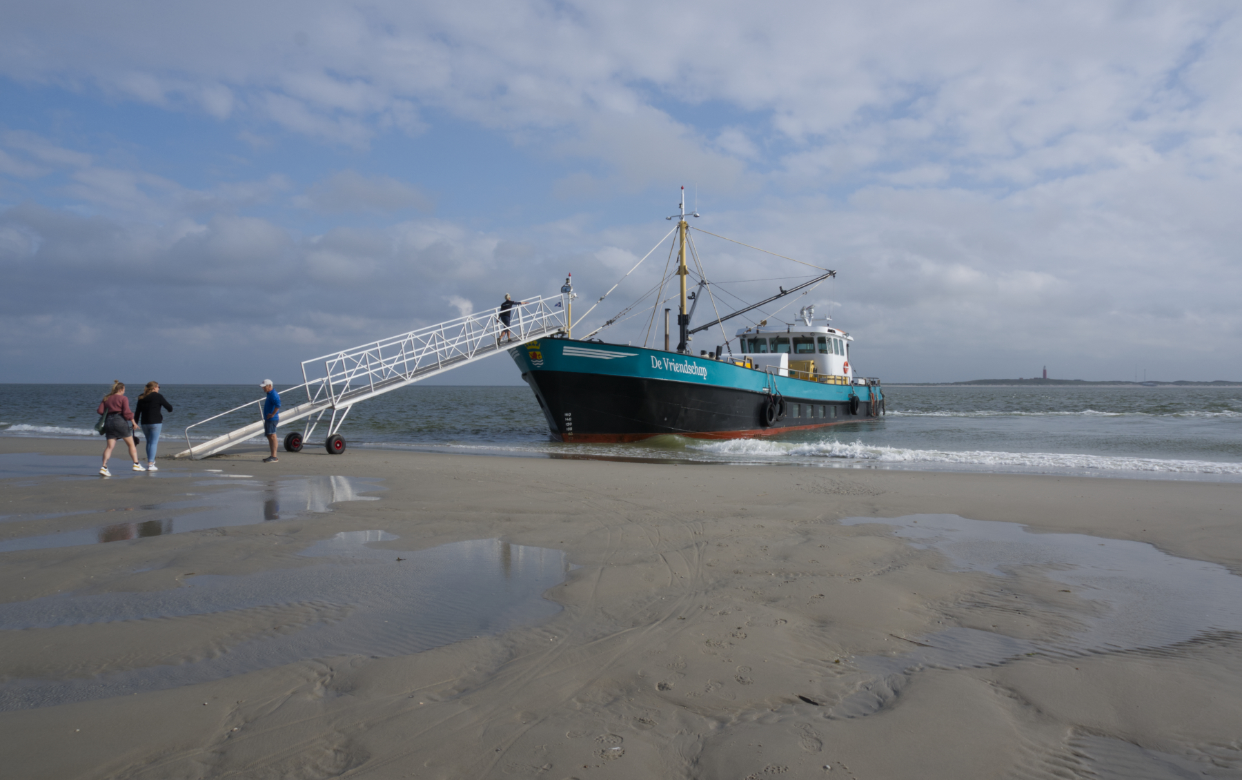 Veerboot de Vriendschap ligt aangemeerd aan de Vliehors om ook passagiers naar Texel over te brengen